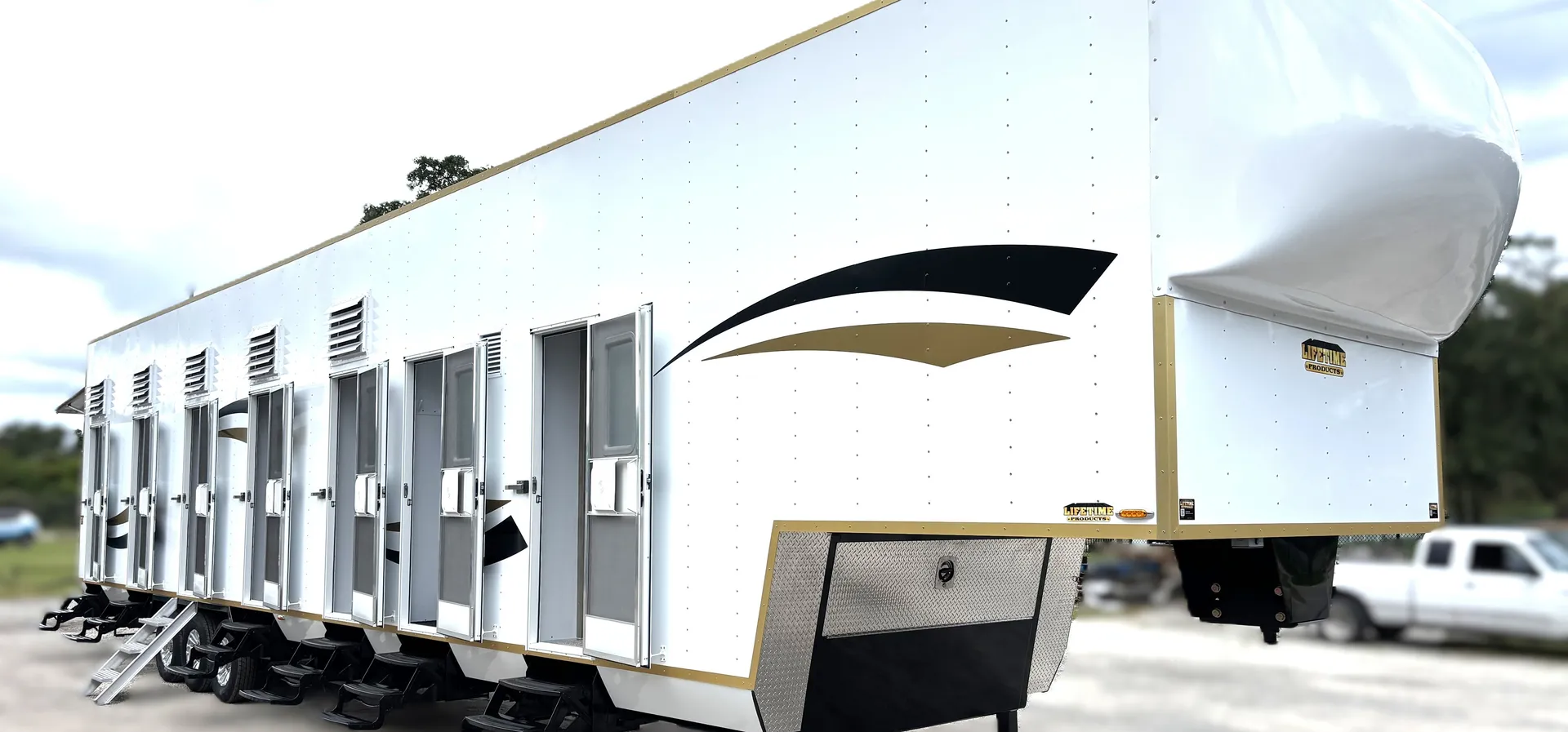 Lifetime multi-room bunkhouse showing its aluminum body, private entries, steps, and trailer foundation